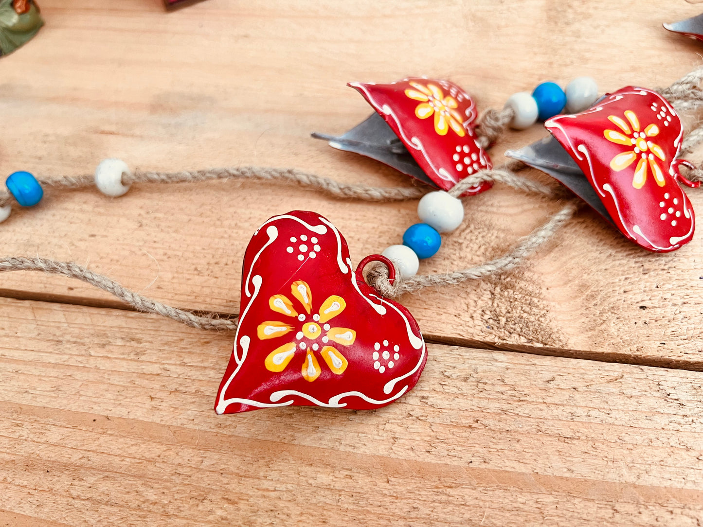 Hand painted red & yellow heart shaped metal bells wind chime on jute twine with glass beads, hanging home living decor bells chime, handmade, fair trade, ethically sourced string of Indian bells