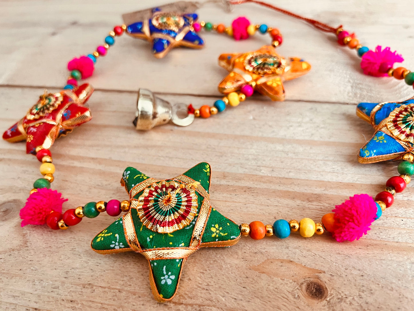 Handmade fair trade ethically sourced star and pom Pom hanging bells wind chime decoration string of stars and bell multicoloured sari fabric bells