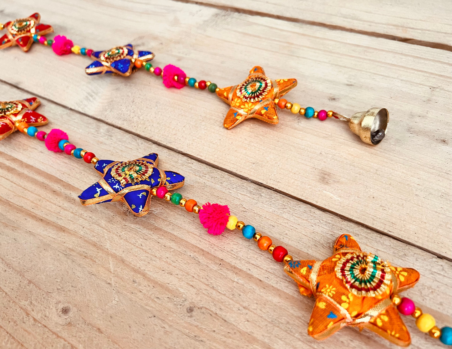 Handmade fair trade ethically sourced star and pom Pom hanging bells wind chime decoration string of stars and bell multicoloured sari fabric bells