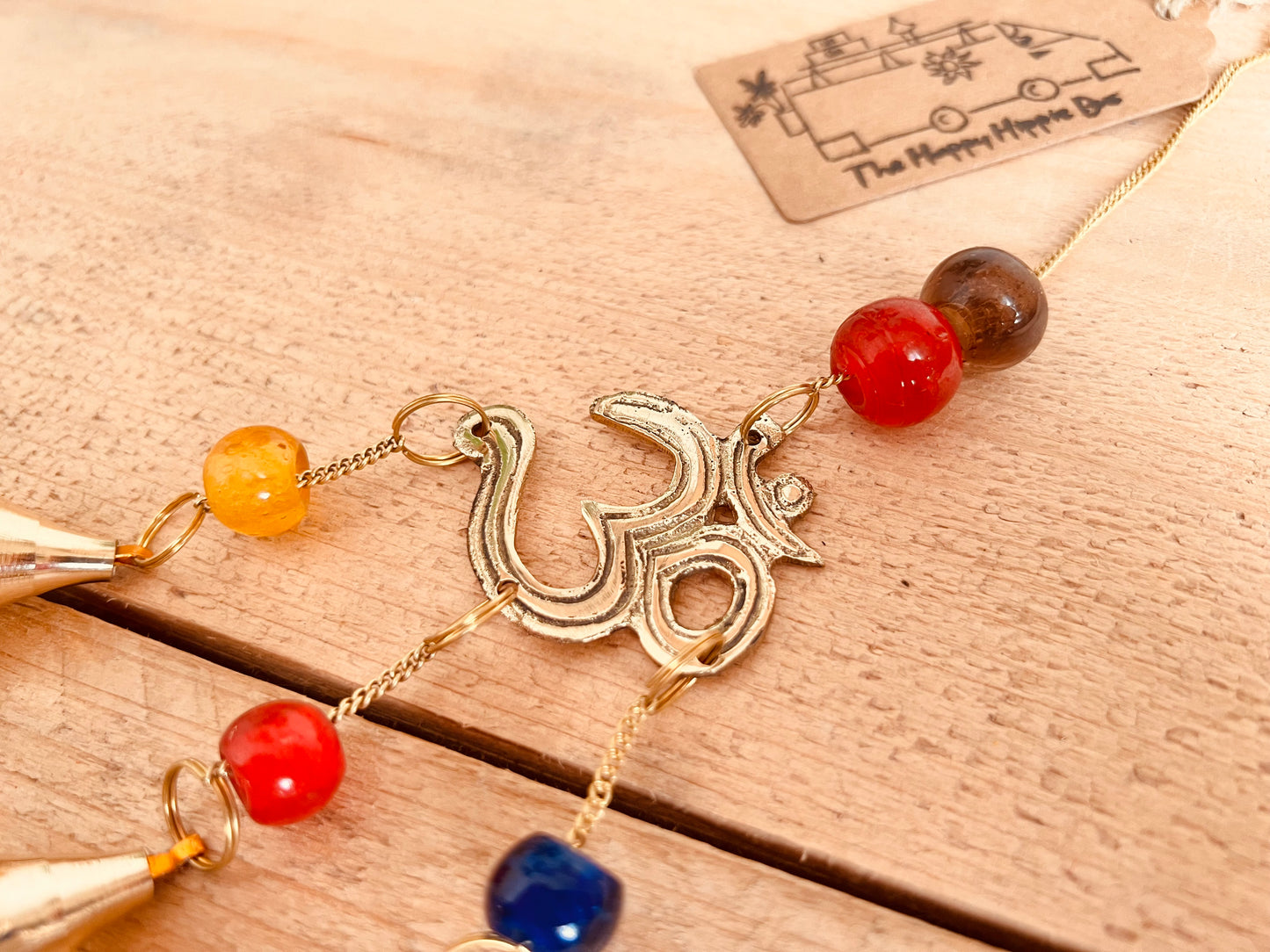 Mini brass wind chime bells Om symbol mini bell chime colourful glass beads recycled metal gold brass chime bells indoor outdoor handmade fair trade ethically sourced mini windchime