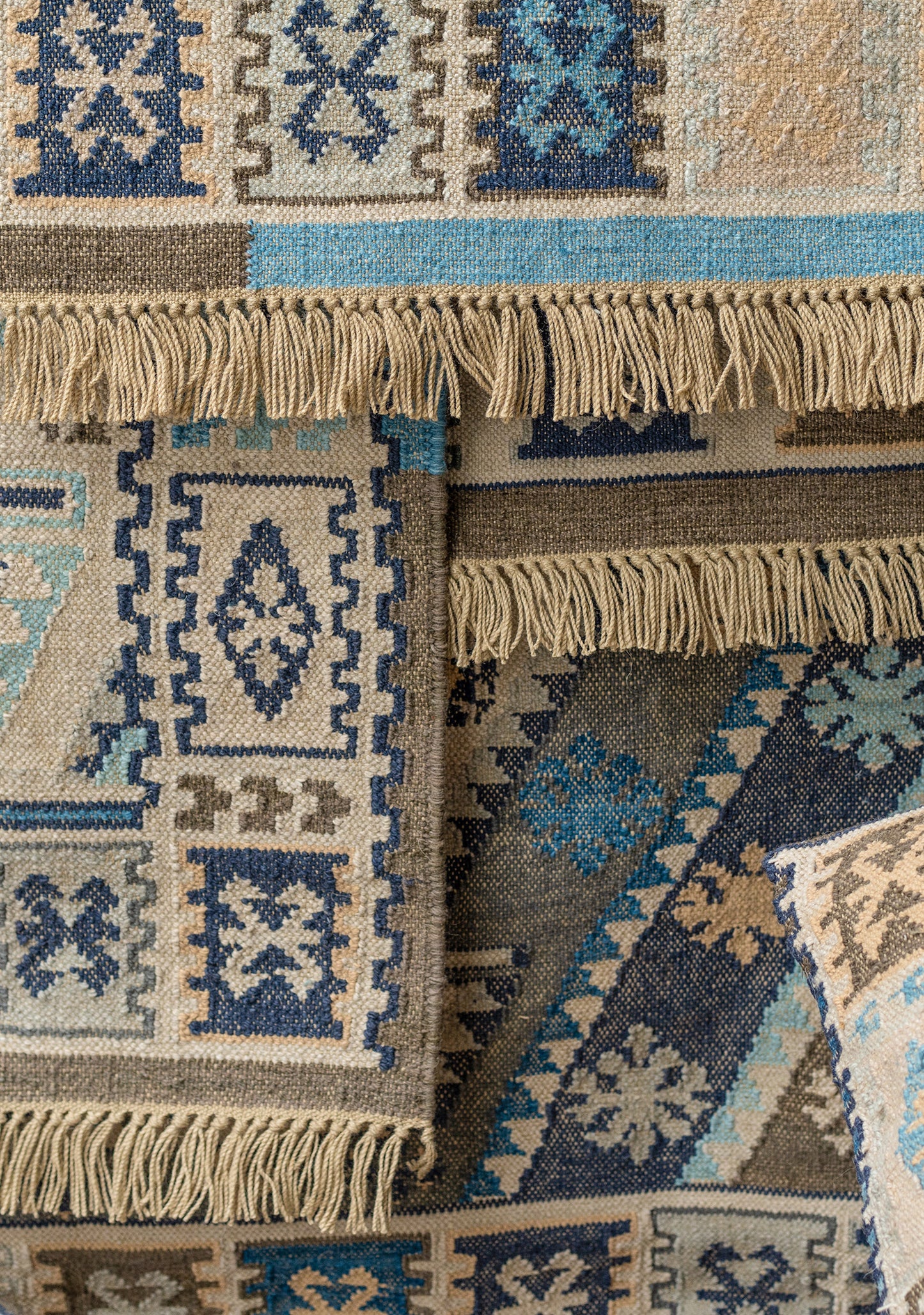 Close-up of patterned rugs with fringes and geometric designs. Fair Trade Recycled Plastic