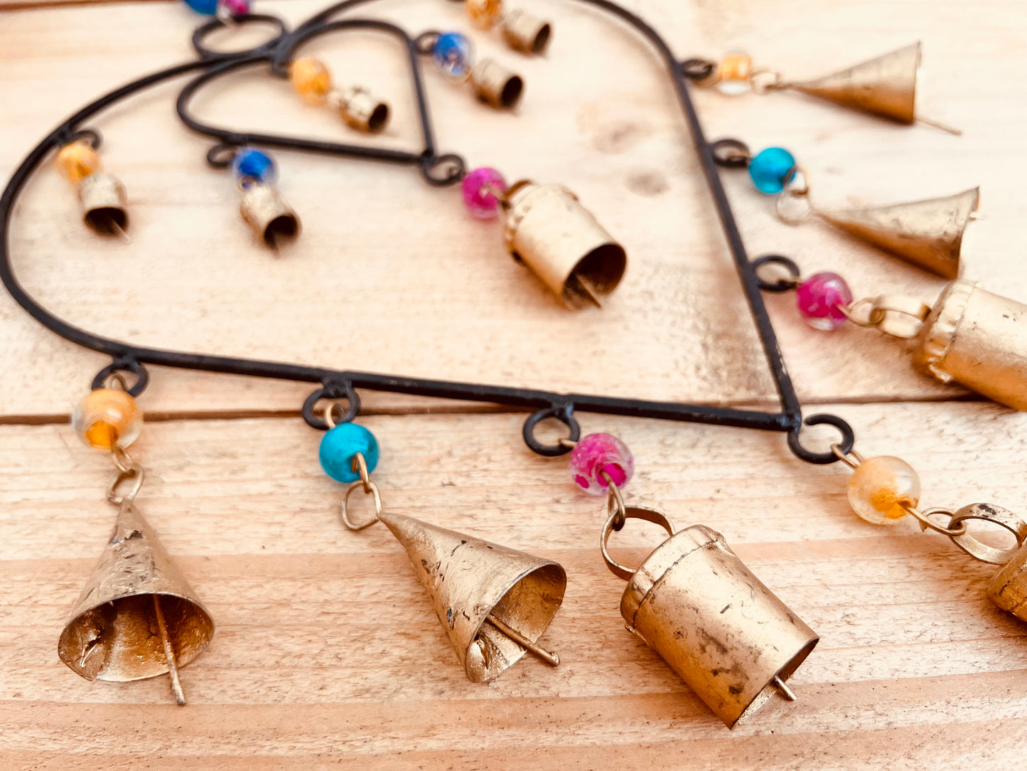 Recycled metal ironwork hanging heart bells wind chime indoor outdoor handmade fair trade boho hanging Indian bell chime, black hearts and gold bells with colourful beads wind bells