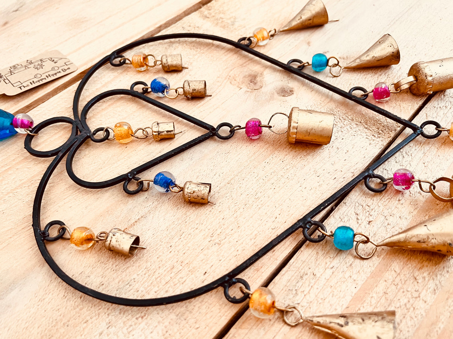 Recycled metal ironwork hanging heart bells wind chime indoor outdoor handmade fair trade boho hanging Indian bell chime, black hearts and gold bells with colourful beads wind bells