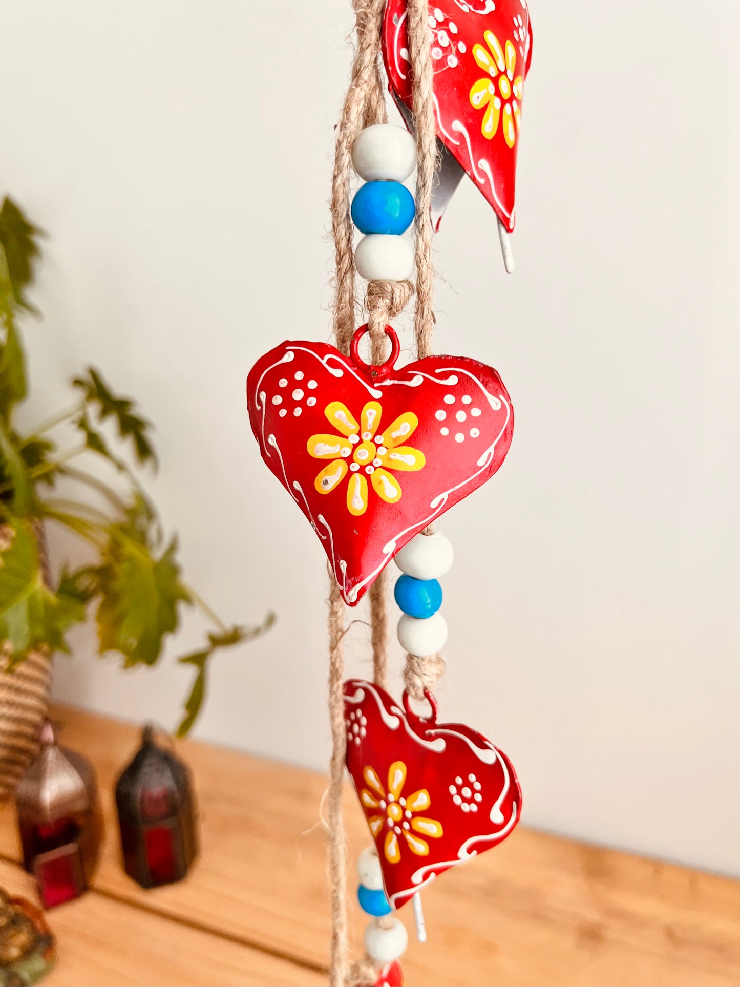 Hand painted red & yellow heart shaped metal bells wind chime on jute twine with glass beads, hanging home living decor bells chime, handmade, fair trade, ethically sourced string of Indian bells
