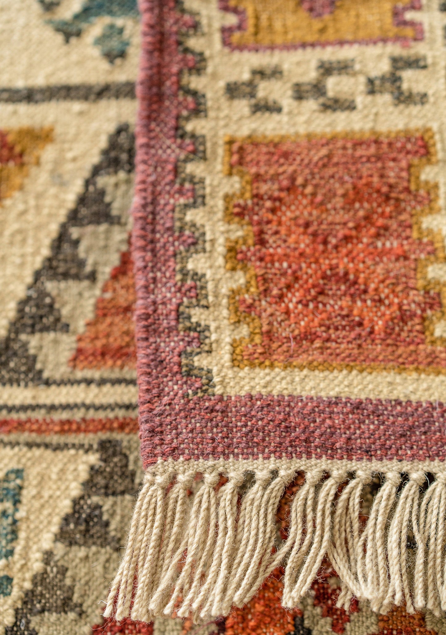 Close-up of a patterned rug with fringes handmade fair trade ethically sourced