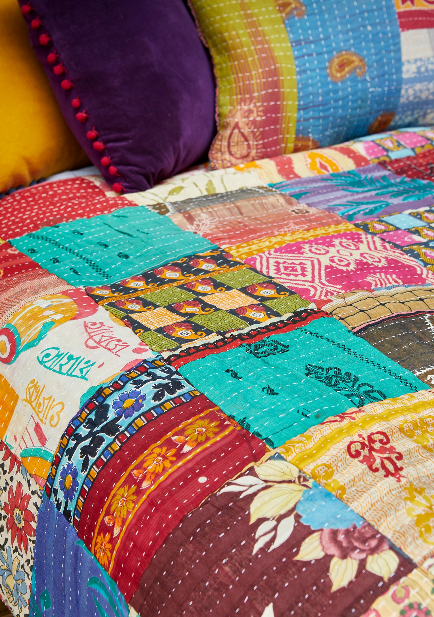 Colourful patchwork quilt with various patterns and colours for sofa bed