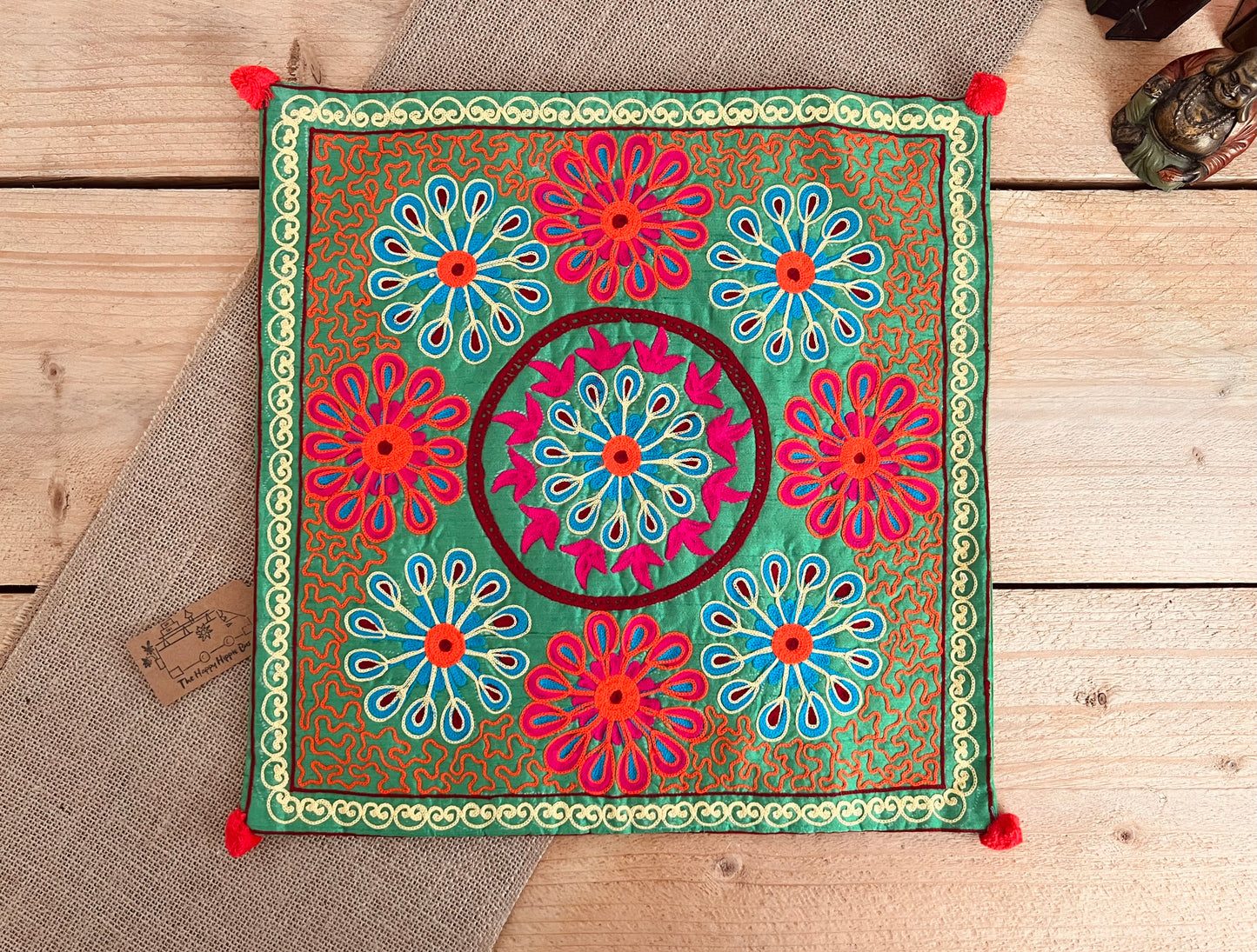 Green flower vibrant silk style fabric cushion covers with hand embroidered boho hippie chic pattern designs in three vibrant colours with Pom Pom edge detail, handmade fair trade & ethical