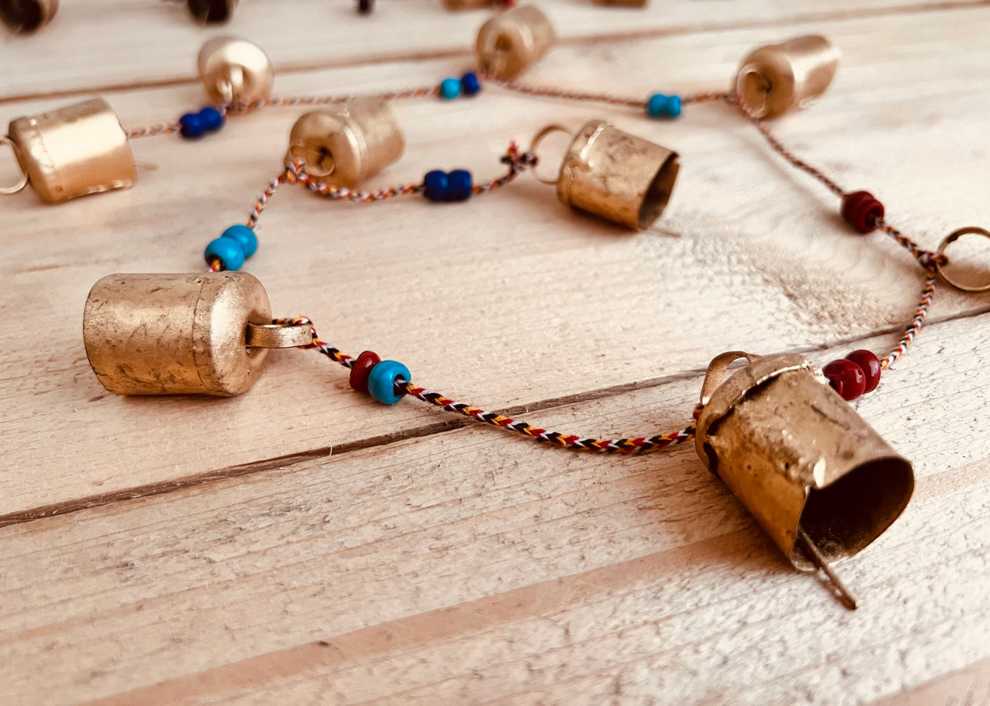 Handmade fair trade ethically sourced Indian string of recycled metal bells wind chime bell & beads