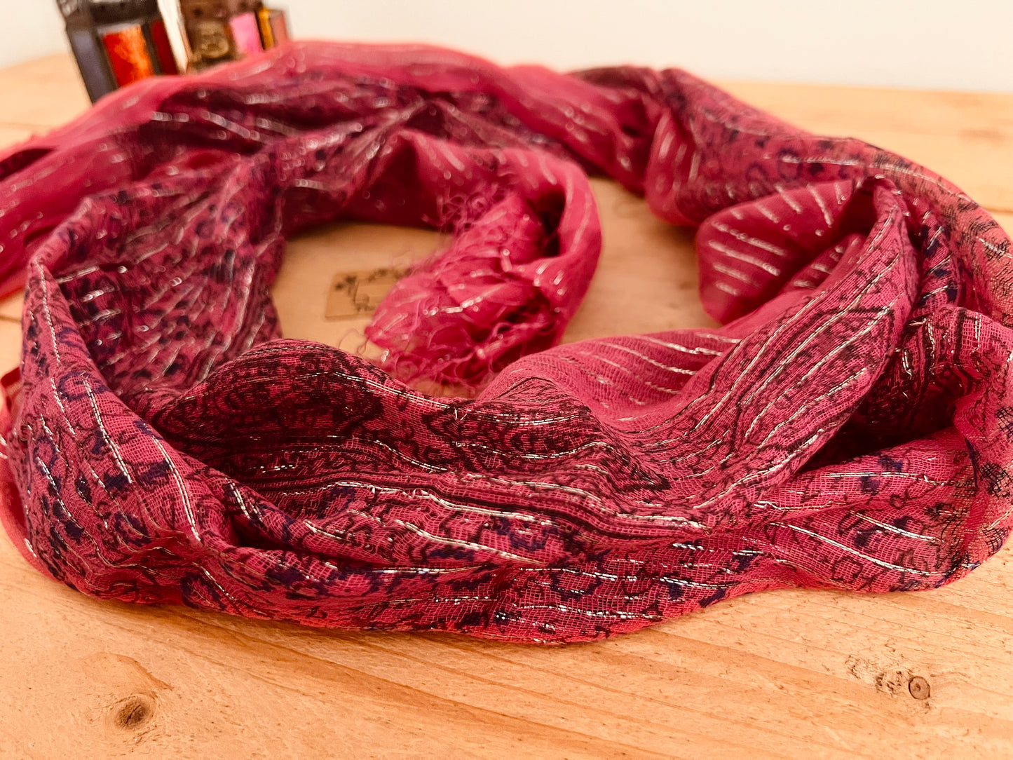 Close up Raspberry red pink Colourful Handmade lightweight boho ethnic print scarf with silver lurex thread, soft lightweight shawl scarves with tassel edge, boho hippie chic accessories 