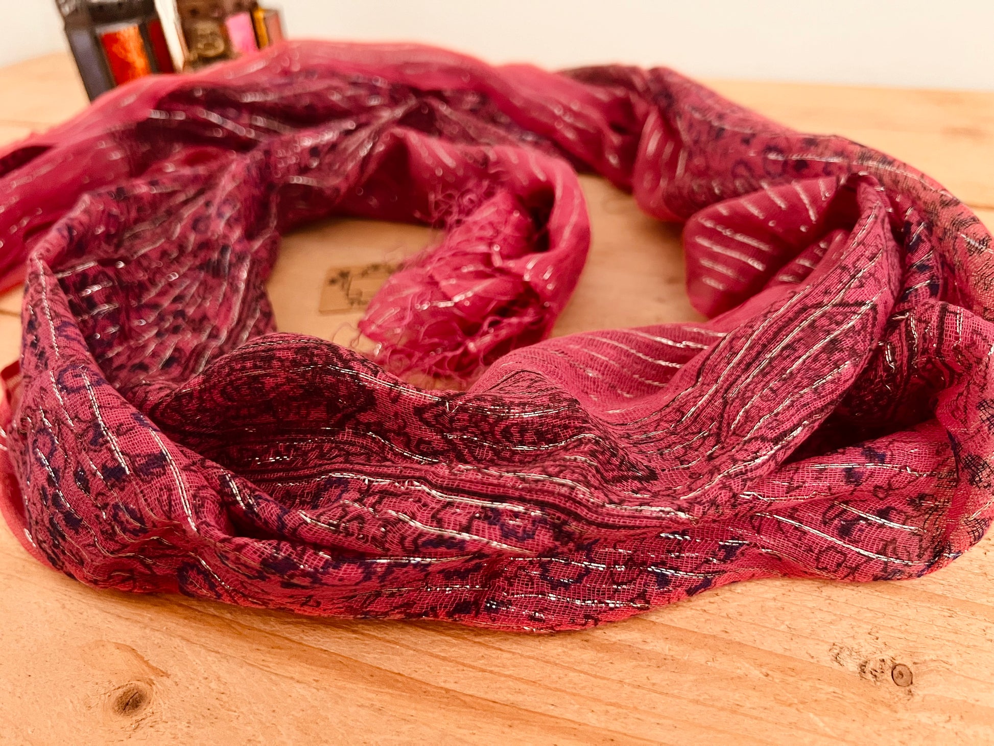 Close up Raspberry red pink Colourful Handmade lightweight boho ethnic print scarf with silver lurex thread, soft lightweight shawl scarves with tassel edge, boho hippie chic accessories 