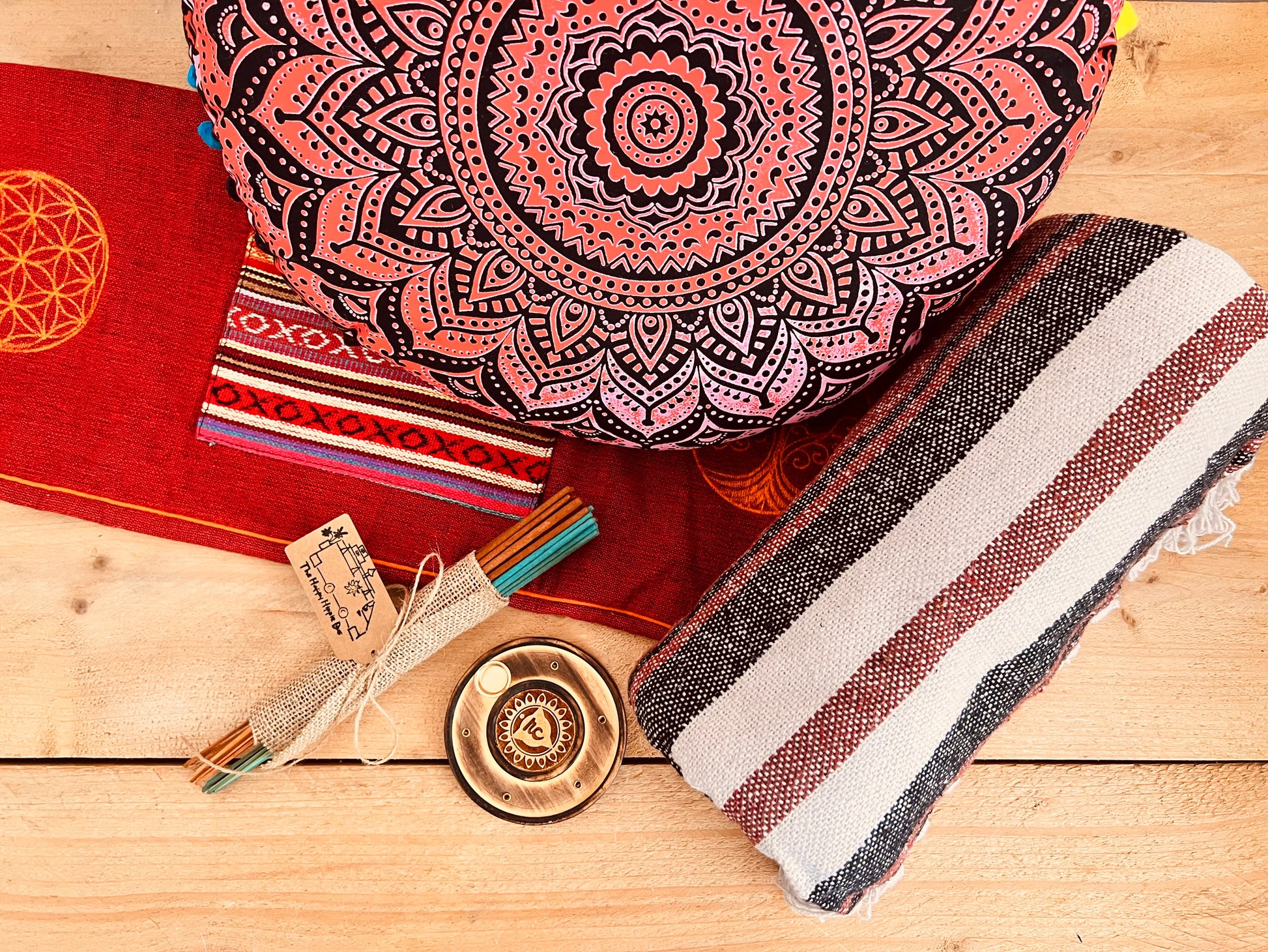 Artisan handcrafted meditation gift set in earthy red tones with yoga cushion, cotton throw, incense and holder – sustainable mindful living decor