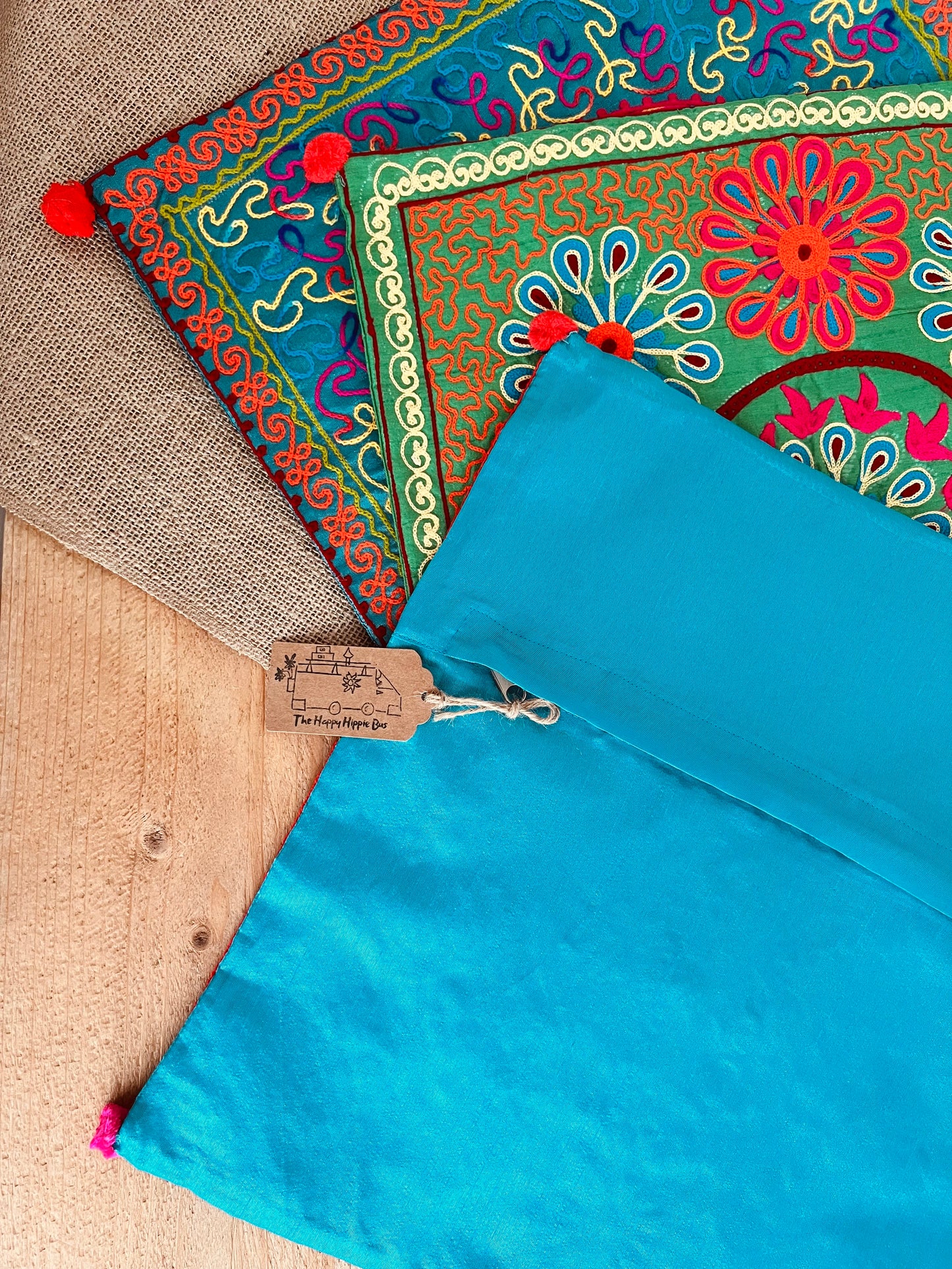 Zipper zip closure vibrant silk style fabric cushion covers with hand embroidered boho hippie chic pattern designs in three vibrant colours with Pom Pom edge detail, handmade fair trade & ethical