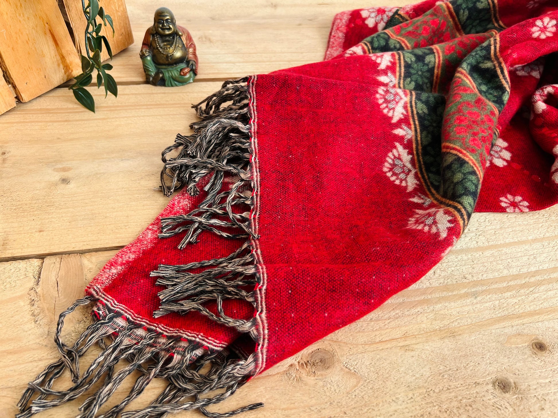 Handwoven red boho throw blanket made from recycled cotton with tassel fringe