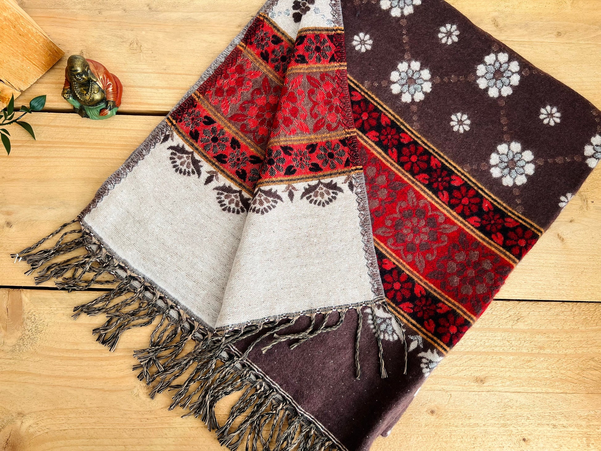Handwoven brown and red boho throw blanket made from recycled cotton with fringe detailing