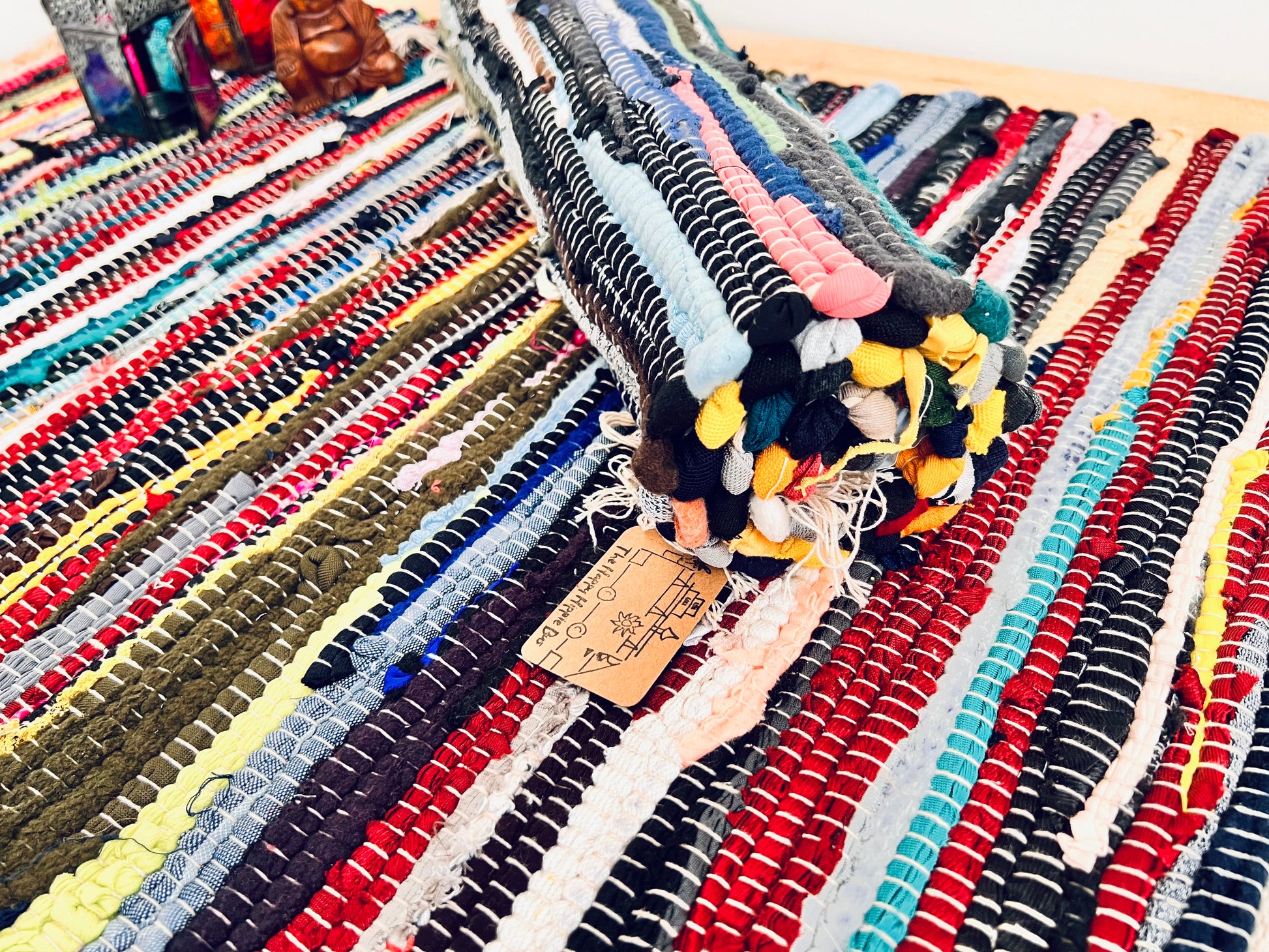 handmade fair trade recycled dark blue rag rug with tassels, small sized mini rag rug, multi coloured cotton rug, boho hippie bohemian home decor rug ethically sourced