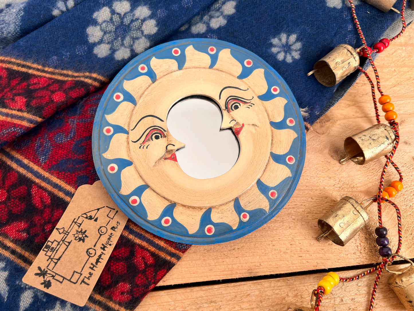 Decorative sun-shaped mirror with colourful hand painted detailing 