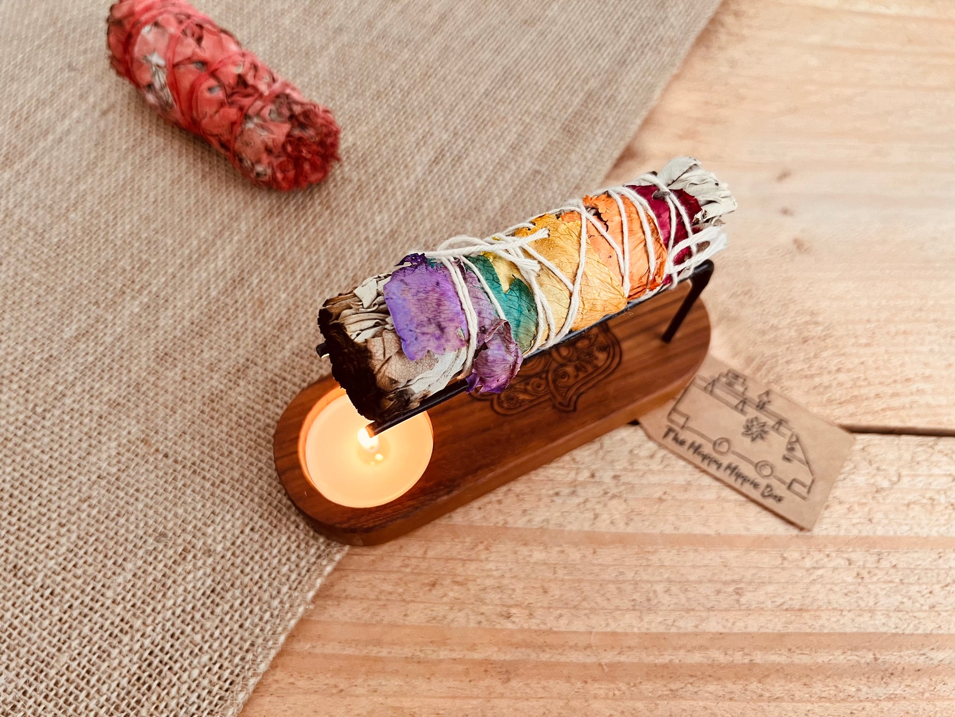 White sage smudge sticks with colourful rose petals shown in smudge Palo Santo incense heater, home fragrance, cleansing ritual incense 