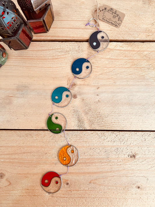 Handmade stained glass yin yang sun catcher with colorful chakra design in red, orange, green, blue, and black circles, spiritual home decor.