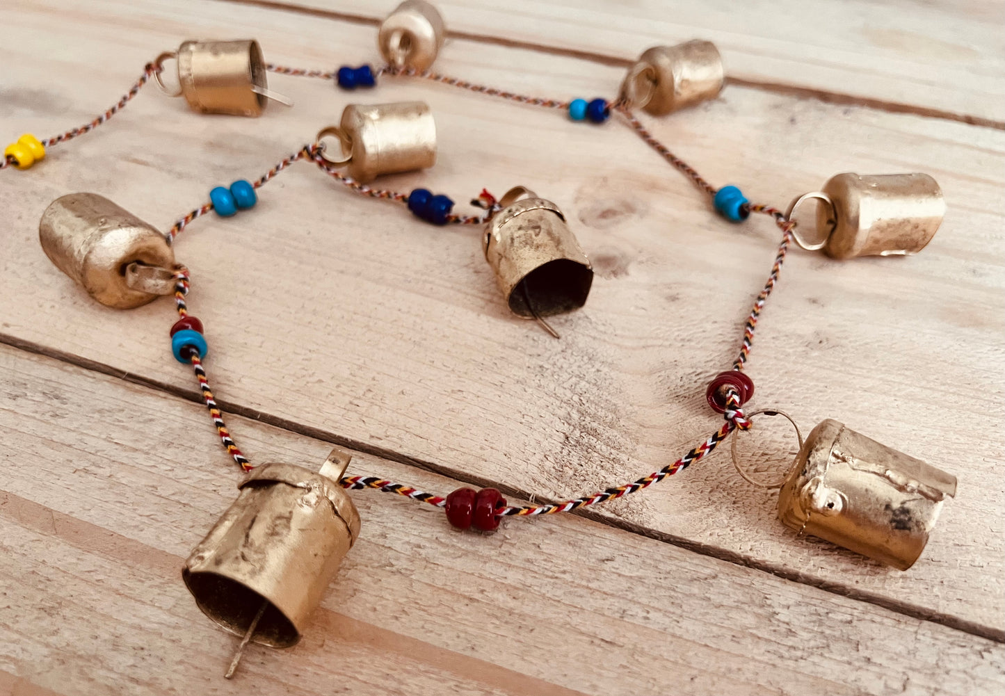 Handmade fair trade ethically sourced Indian string of recycled metal bells wind chime bell & beads