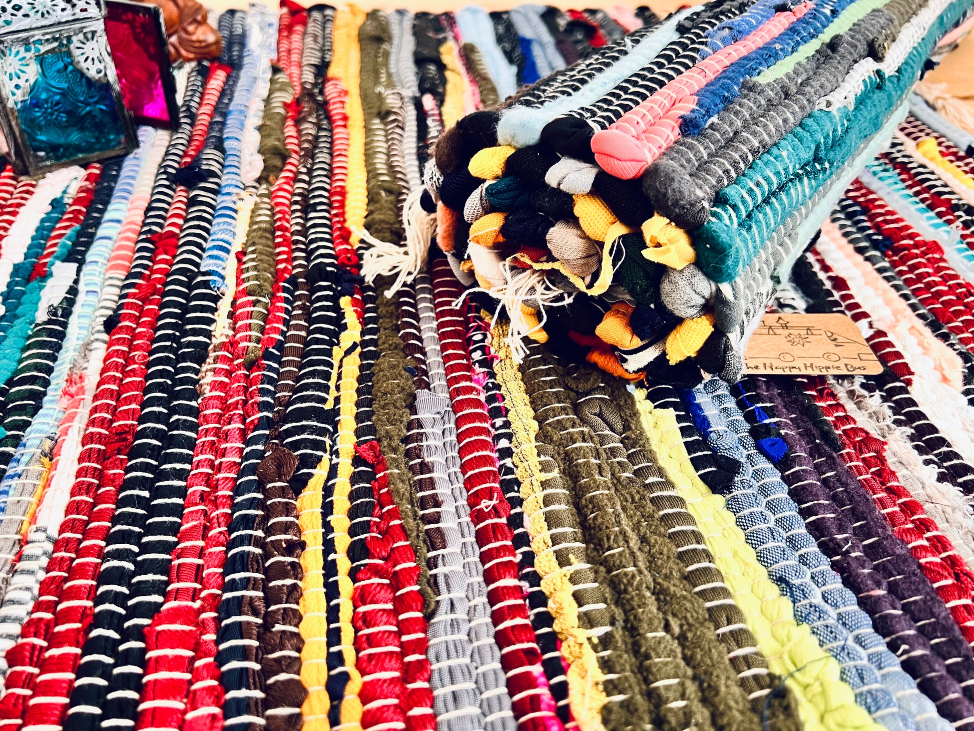 handmade fair trade recycled dark blue rag rug with tassels, small sized mini rag rug, multi coloured cotton rug, boho hippie bohemian home decor rug ethically sourced