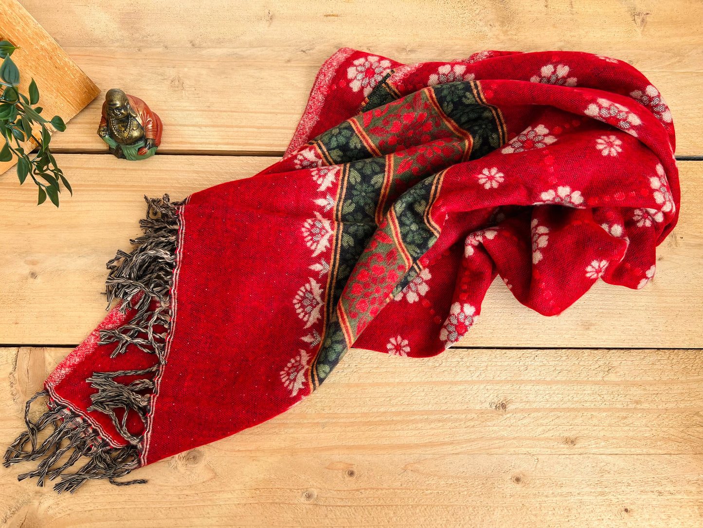Handwoven red boho throw blanket styled on bed for cosy home décor