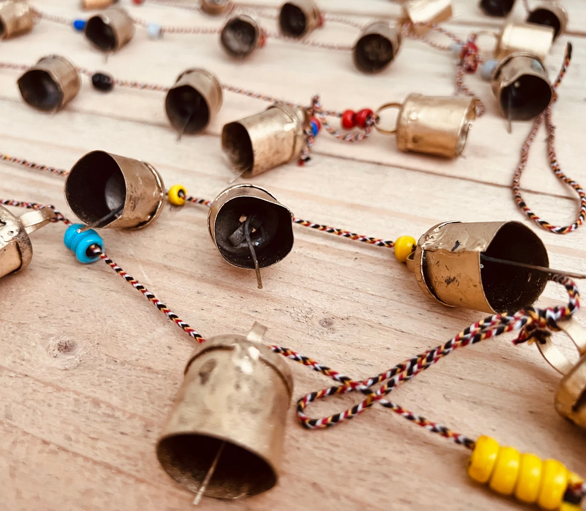 Handmade fair trade ethically sourced Indian string of recycled metal bells wind chime bell & beads