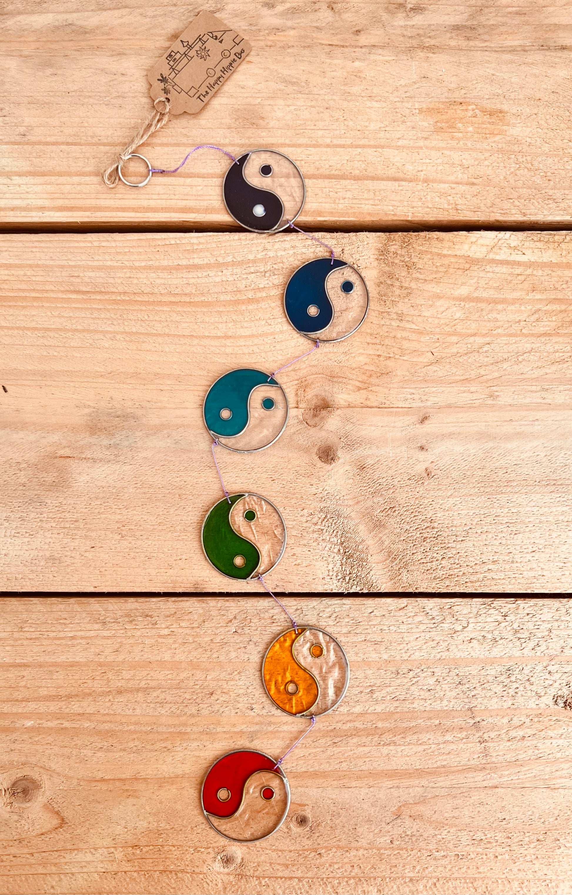 Handcrafted yin yang chakra sun catcher with stained glass in red, orange, green, blue, and black
