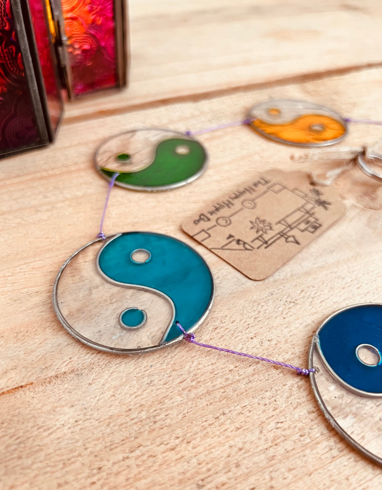 Boho stained glass yin yang window hanging in rainbow chakra colours for meditation and balance