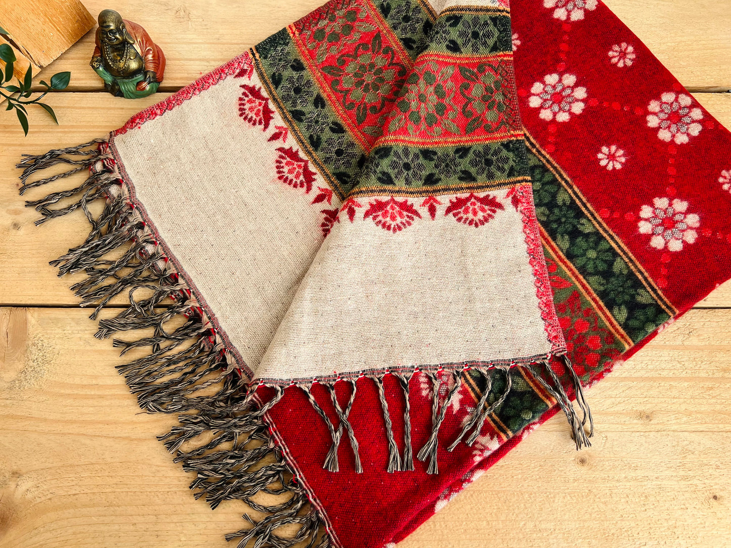 Bohemian handwoven red throw blanket folded to highlight textured weave and colour