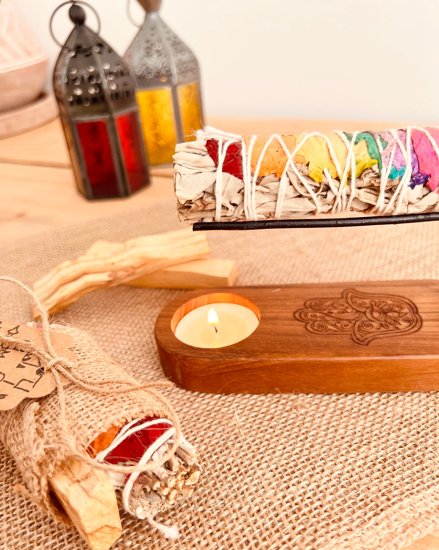 White sage smudge sticks with colourful rose petals shown in a smudge Palo Santo heater, home fragrance, cleansing ritual incense 