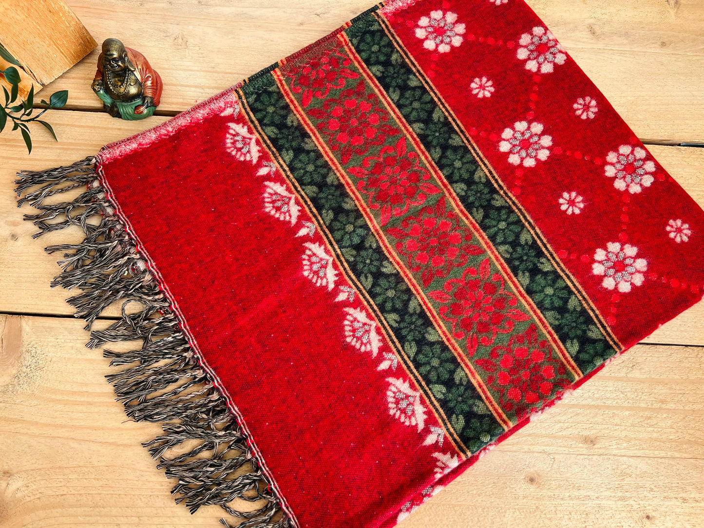 Handwoven red boho throw blanket made from recycled cotton with ethnic floral pattern