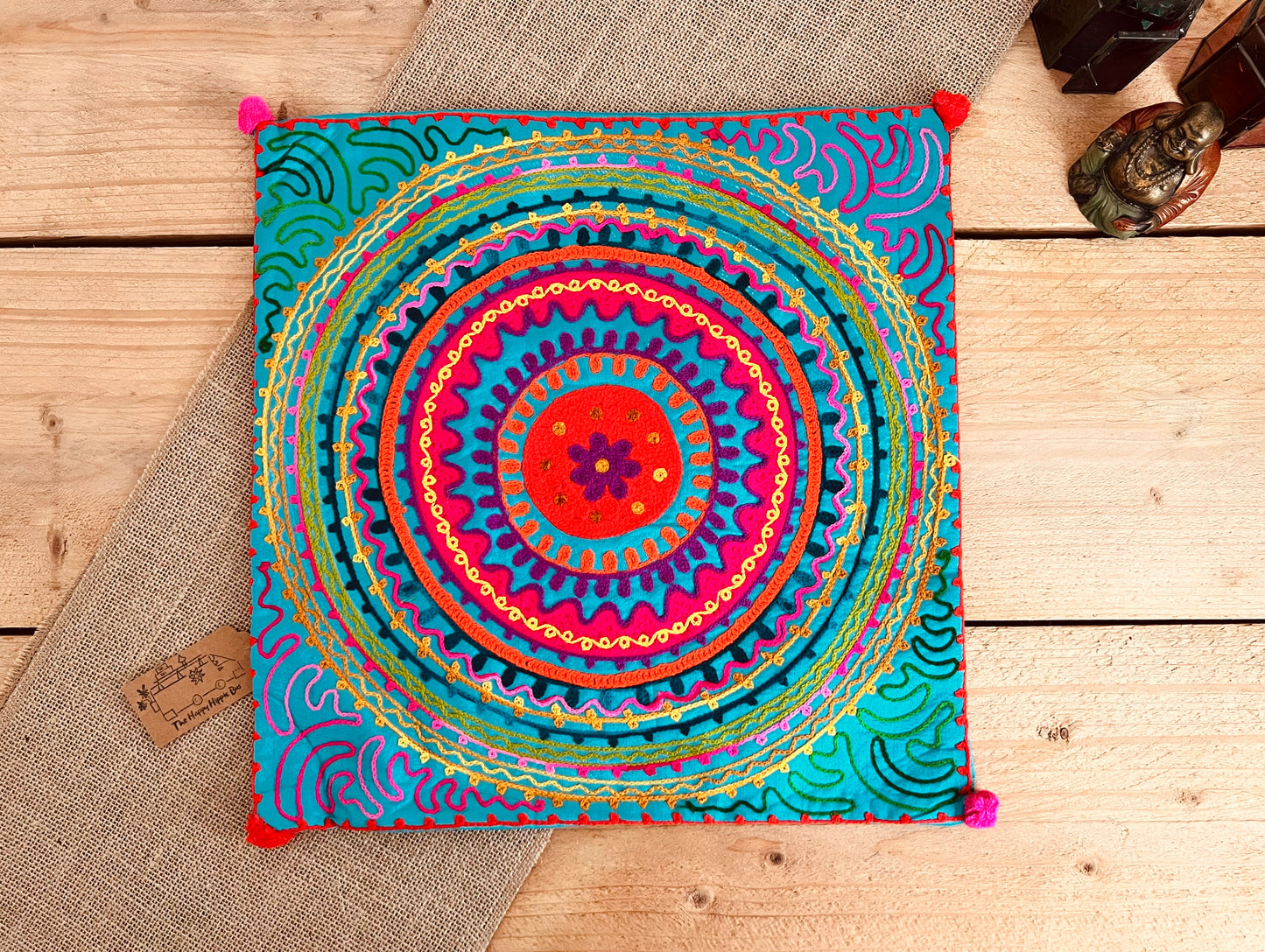 Bright blue mandala vibrant silk style fabric cushion covers with hand embroidered boho hippie chic pattern designs in three vibrant colours with Pom Pom edge detail, handmade fair trade & ethical