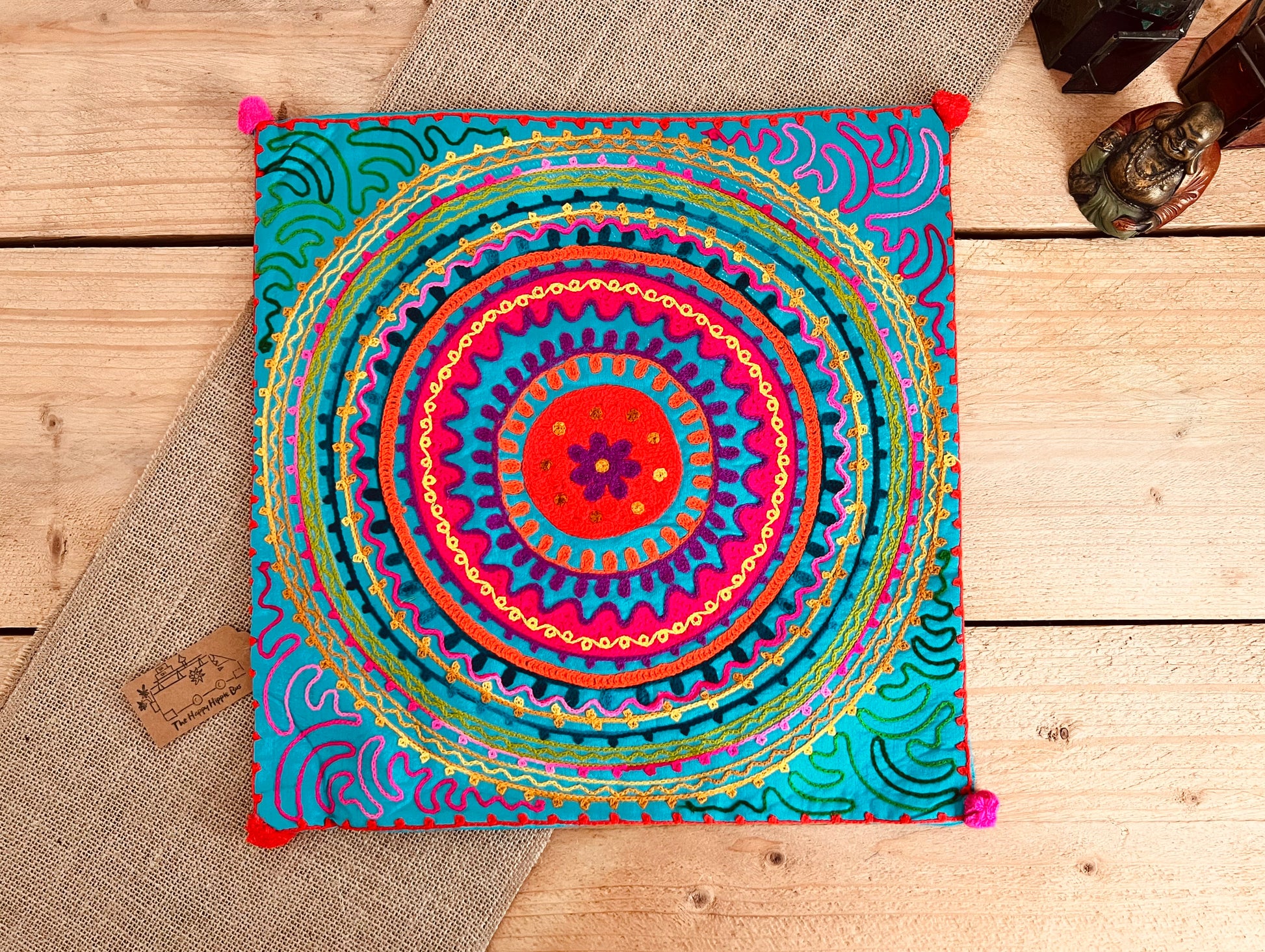 Bright blue mandala vibrant silk style fabric cushion covers with hand embroidered boho hippie chic pattern designs in three vibrant colours with Pom Pom edge detail, handmade fair trade & ethical