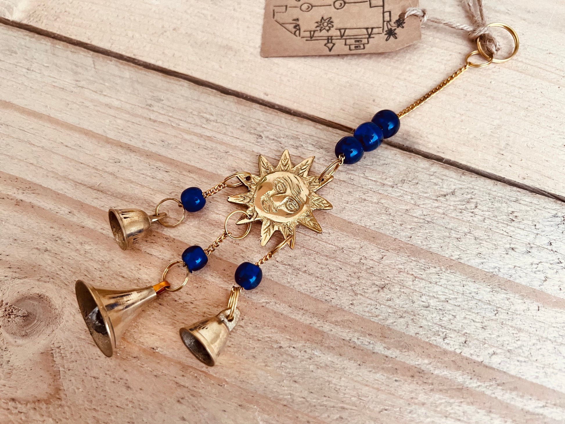 Mini brass sun sunshine small wind chime bell handmade fair trade ethically sourced recycled metal mini bell with blue glass beads