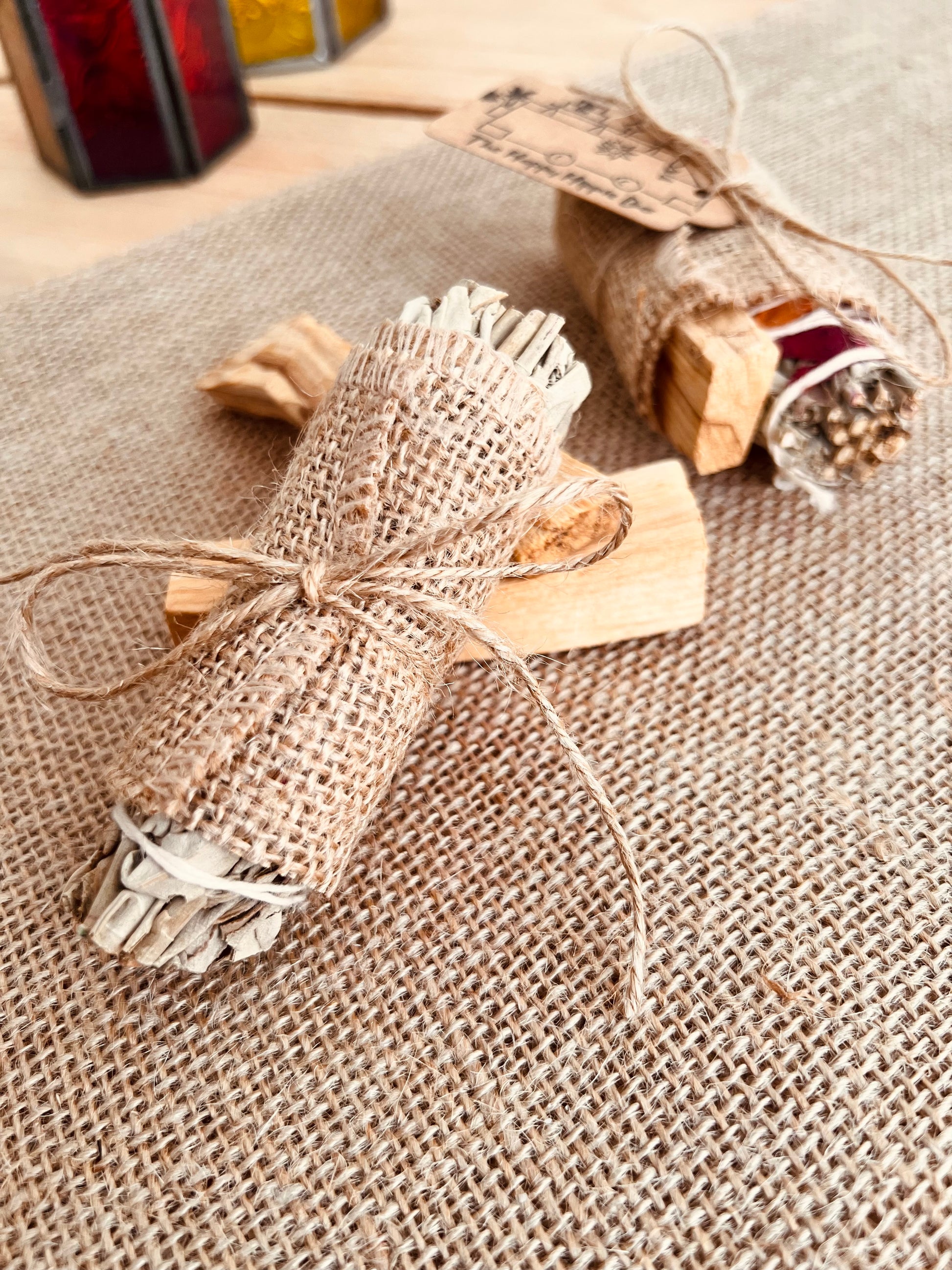 White sage smudge sticks with colourful rose petals wrapped with Palo Santo sticks in eco hessian burlap wrap, home fragrance, cleansing ritual incense 