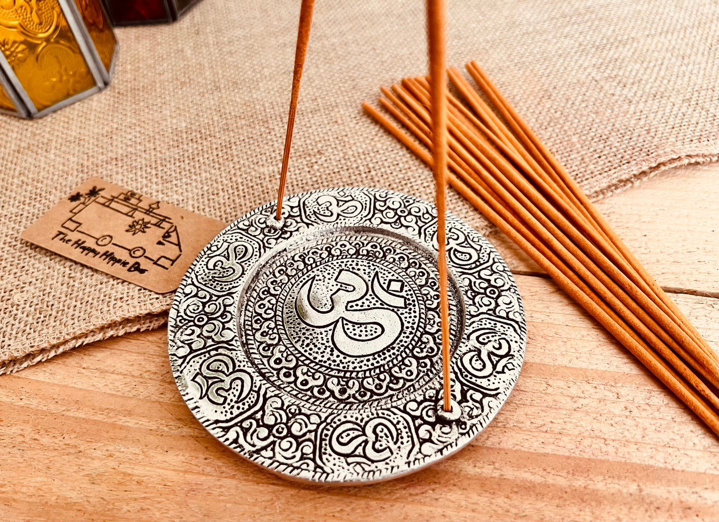Metal plate incense stick holder burner derailed with intricate yoga Om Symbol design pattern in silver finish, handmade fair trade and ethically sourced, perfect for burning two incense sticks 