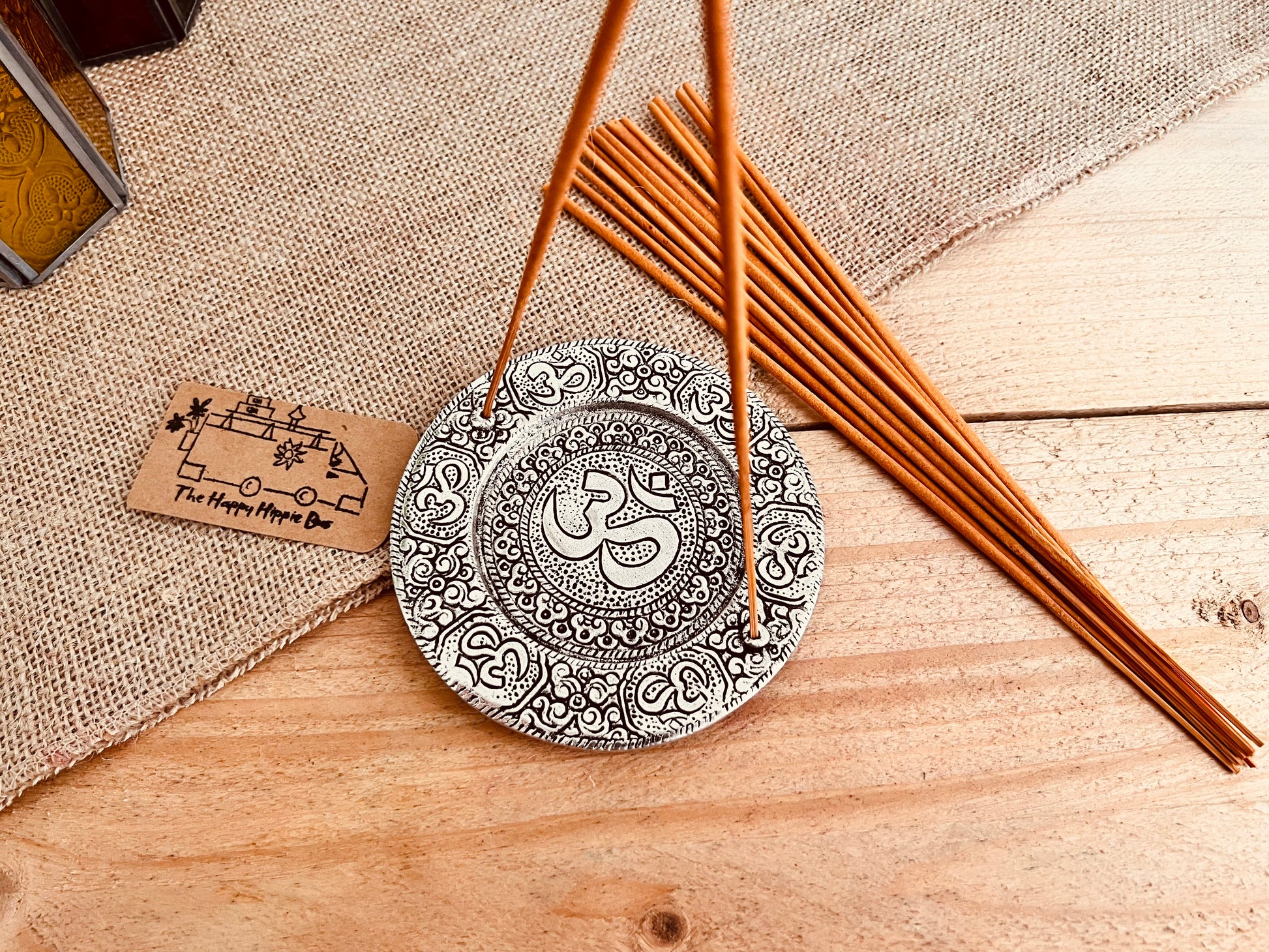 Metal plate incense stick holder burner derailed with intricate yoga Om Symbol design pattern in silver finish, handmade fair trade and ethically sourced, perfect for burning two incense sticks 