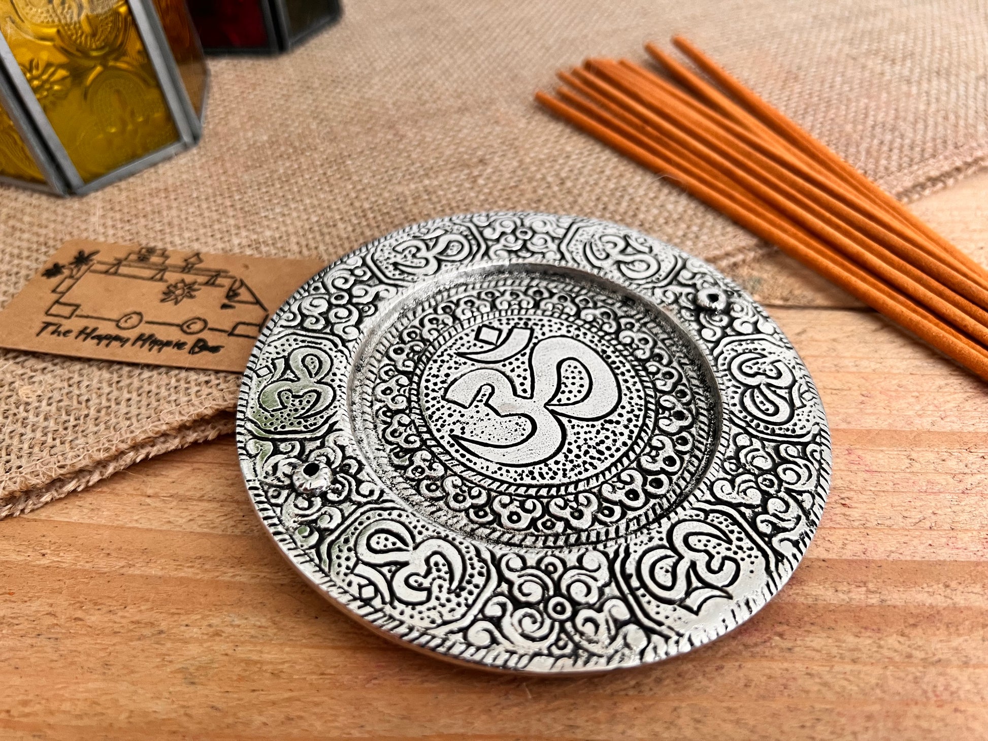 Metal plate incense stick holder burner derailed with intricate yoga Om Symbol design pattern in silver finish, handmade fair trade and ethically sourced, perfect for burning two incense sticks 