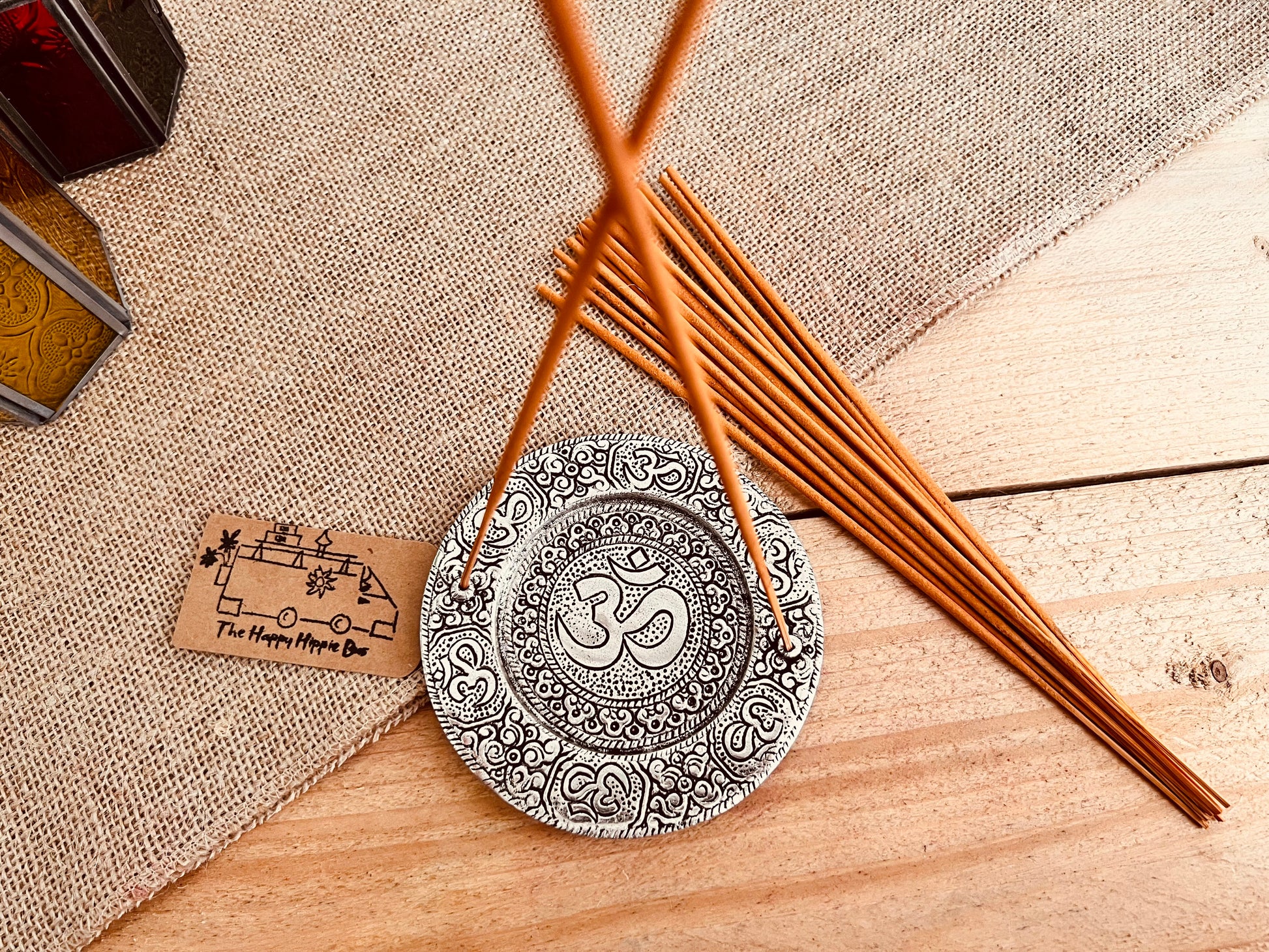 Metal plate incense stick holder burner derailed with intricate yoga Om Symbol design pattern in silver finish, handmade fair trade and ethically sourced, perfect for burning two incense sticks 